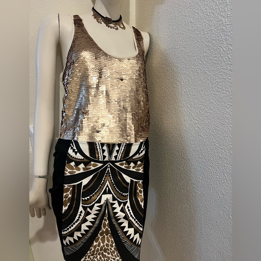 Gold top /Black miniskirt Zip close in the bag. Size small from mink pink